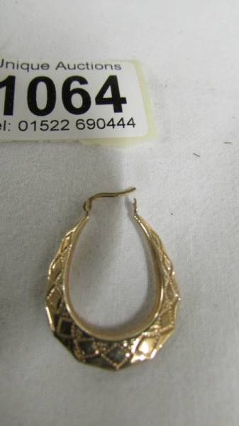 A pair of 9ct gold textured hoop earrings. - Image 2 of 2