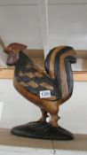 A carved wood cockerel.