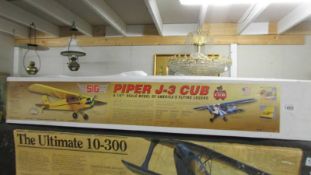 A boxed 1/5 scale Piper J-3 Cub R.C. model aircraft kit, unchecked for completeness.