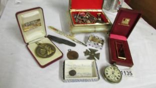 An Onyx jewellery box with cuff links, badges, medallions etc.,