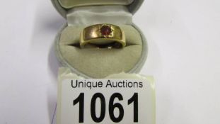 A gold ring set red stone, (Has been made smaller so hall mark removed) size R. 8.9 grams.