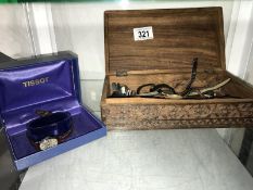 A mixed lot of wristwatches in a carved wooden box