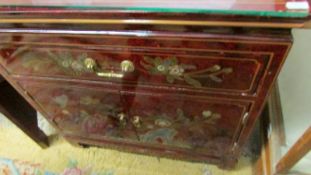 A lacquered two door one drawer cupboard.