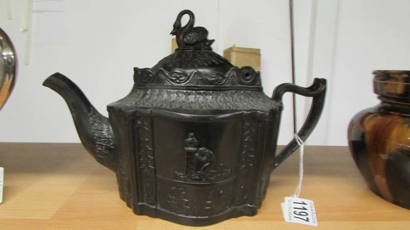 A Victorian black mourning teapot.