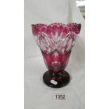 A red overlaid glass vase.