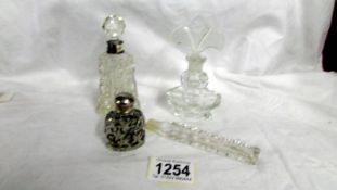 Four scent bottles including one with silver collar (one missing stopper).