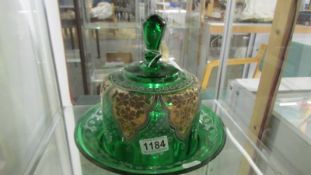 A Victorian hand decorated green glass stilton dome (a/f, many chips to base).