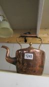 A Victorian copper kettle.