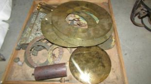 A box of assorted clock parts including dials, pendulums etc.,