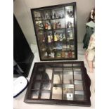 2 dark wood mirror backed small compartment trinket display cabinets and contents including Wade,