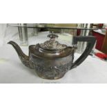 A decorative silver teapot, approximately 330 grams.