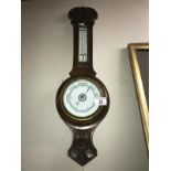 An Edwardian oak aneroid barometer COLLECT ONLY