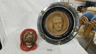 A heavy 11" diameter ceramic wall hanging plate with fittings,with bust of a man.
