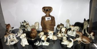 A large selection of pottery dog ornaments including an E.T. money box