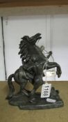 A metal figure of a man with horse.