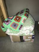A double patchwork style bedcover with 2 pillow cases and a crocheted throw