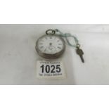 A Kendal and Dent silver pocket watch with key, in working order.
