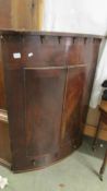 A Victorian bow front corner cupboard.
