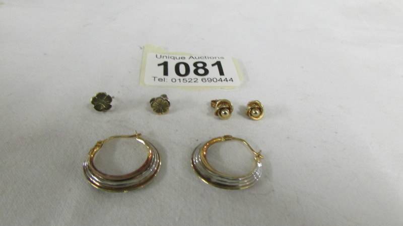 A pair of 9ct gold hoops together with two pairs of 9ct gold studs.