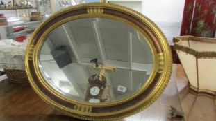 A good quality oval gilt framed bevel edged mirror.