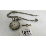 A Victorian ladies silver fob watch with ornate white metal chain.