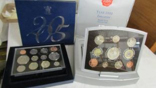 A 2005 UK Battle of Trafalgaar Nelson proof set and a year 2000 executive proof coin collection.