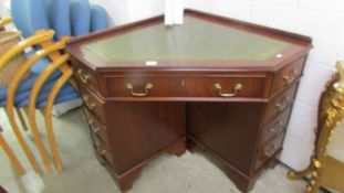 A mahogany corner fitting desk.