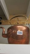 A Victorian copper kettle.