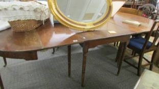 A D end dining table comprising centre drop leaf table and two D ends.