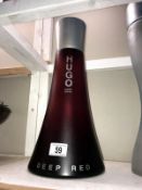 A large Hugo Boss Deep Red perfumery/chemist shop display bottle, height 41cm, (the contents are not