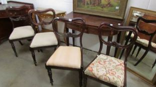 A set of four mahogany dining chairs.