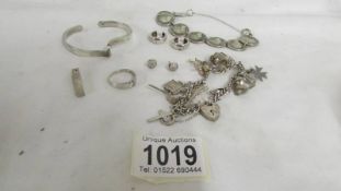 A silver charm bracelet, silver coin bracelet and other silver items. (Approximately 65 g)