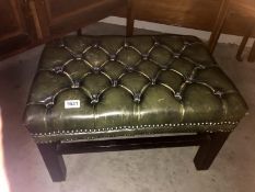 A deep buttoned green leather foot stool