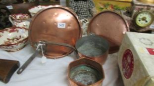 Two 19th-century copper pan lids, a copper saucepan and another copper pan.