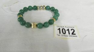 A 14 ct gold jade/jadite bracelet.