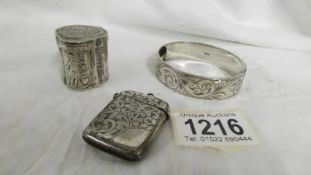 A silver vesta case, a silver snuff box and a silver bangle, 65 grams.