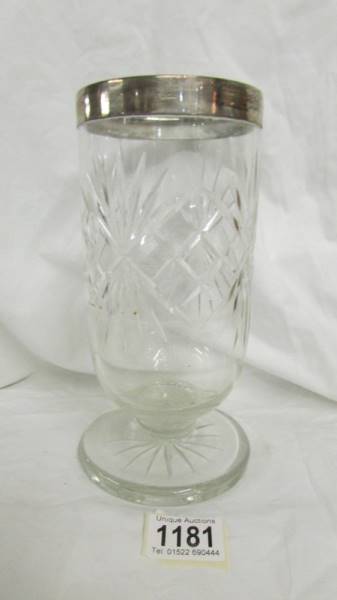 A cut glass vase with silver collar.