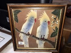 A framed silk picture of 2 cockatoo parrots (36cm x 36cm)