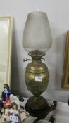 A Victorian brass oil lamp complete with shade.