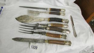 A mixed lot of carving forks, sharpening steel and fish servers.