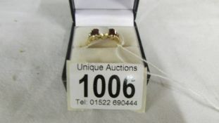 A 10k diamond, garnet and opal ring, size O.