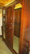 An Edwardian mahogany inlaid combination wardrobe.