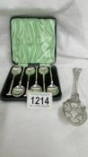 A cased set of six silver coffee spoons and a Victorian fruit spoon.