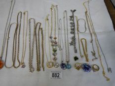 A mixed lot of pendants, rings, yellow and white metal chains etc.,