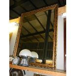 A large gilt framed bevel edged mirror. (Collect only)