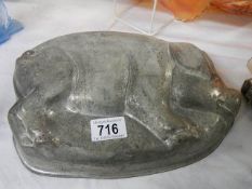 A metal pig shaped bread mould.