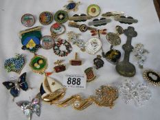 A mixed lot of brooches, badges etc.,