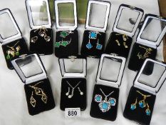 Ten gem set pendant and earring sets.