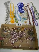 A mixed lot of necklaces and beads.