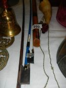 Two violin bows, a wooden flute and a bone horn.